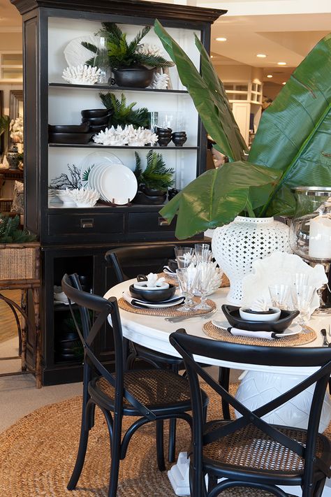 Portland Black Hutch Single behind white dinning table. Black Coastal Living Room, Black And White Tropical Decor, French Polynesian Decor, British Colonial Dining Table, Tropical Colonial Decor, Black And White Coastal Decor, British Colonial Dining Room, Black And White Coastal, Tropical Dining Room