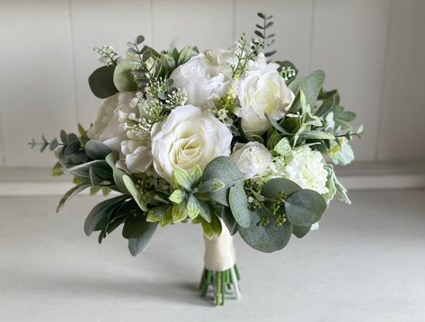 Elegant white and sage green silk wedding flowers. Artificial wedding bouquet. White wedding flowers. #wedding #weddingbouquet #bridalbouquet #whiteweddingflowers Green And White Bouquets, Safe Green Wedding, Sage Green And Champagne Wedding, Small Bridal Bouquets, Silk Flower Wedding Bouquet, Sage Green Flowers, Dark Wedding Theme, Green Wedding Bouquet, White Flower Bouquet