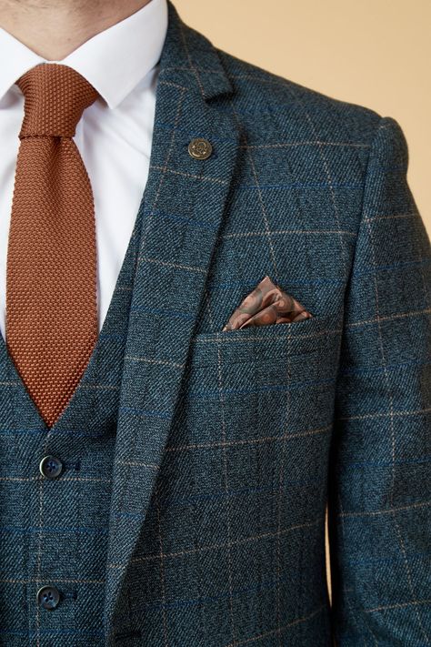 Show up in style with the blue Scott three piece suit. This vintage inspired suit draws inspiration from old age country tweeds, featuring a subtle check laid upon a durable heavyweight fabric, making it ideal for imitating that suave Peaky Blinders style. Character is added with the navy velvet contrast pocket trims and an eye-catching orange paisley pocket square peeking through the top pocket. Model wears size 40R blazer, 40R waistcoat & 34R trousers. Features Slim fit Single-breasted Notch l Non Traditional Suits For Men, Wedding Suits Groom Navy Blue, Double Breasted Tweed Suit, Autumn Suit Men Wedding, Irish Wedding Suit, Mens Wedding Suits Summer, British Suits Men Wedding, Art Deco Wedding Mens Suits, Unique Mens Suits Wedding