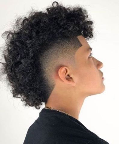 The Afro Hawk with a mid taper for black men is a dynamic hairstyle that combines the natural texture of an afro with the boldness of a mohawk. The Afro Hawk with a mid taper is not just a hairstyle; it's a statement, allowing black men to embrace their individuality with confidence and style. Afro Hawk, Frohawk Fade, Fade Curly Hair, Mid Taper, Man Haircuts, Short Sides Long Top, Curly Mohawk Hairstyles, Top Hairstyles For Men, Male Haircuts Curly