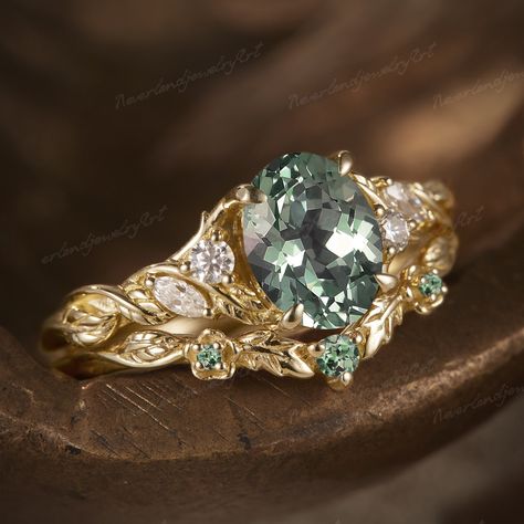 RING DESCRIPTION ✦Engagement ring Center Stone: Lab Grown Green Sapphire Shape: Oval shaped Size: 6x8mm Accent Stone: Natural Diamond/ Moissanite Shape: Round and marquise-shaped Weight: approx 0.13ct Clarity: SI-VS Color: G-H ✦Band width: approx 1.5mm ✦Wedding band Stone: Natural green Sapphire  Shape: Round and marquise-shaped ✦Band width: approx 1.5mm Total Weight: about 3.91g Metal: 14k or 18k solid gold Available in rose, yellow or white solid 14 or 18k gold. ✦Visit my shop for more jewelry Olive Engagement Ring, Green Sapphire Engagement Ring Gold, Green Gem Engagement Ring, Green Sapphire Engagement Rings, Emerald Engagement Ring Stack, Vine Rings, Green Emerald Wedding Ring, Green Gemstone Engagement Rings, Sapphire Engagement Ring Gold