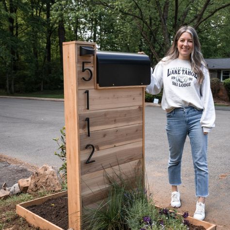 Build a modern Mailbox with solar lights and surrounding flower bed🌿🥀 #modernmailbox #home #outdoor #homeoutdoor #cedarmailbox #moderncedarmailbox #diyproject #diymailbox #diymodernmailbox #diymoderncedarmailbox #outdoordiy #easydiy #easysummerdiy Diy Farmhouse Mailbox Ideas, Mid Modern Mailbox, Cute Mailbox Ideas Curb Appeal, Farmhouse Mail Box Ideas, Modern Farmhouse Mailbox Post, Sidewalk Mailbox Ideas, Mailbox Modern Design, Pallet Wood Mailbox Ideas, Wood Slat Mailbox Ideas