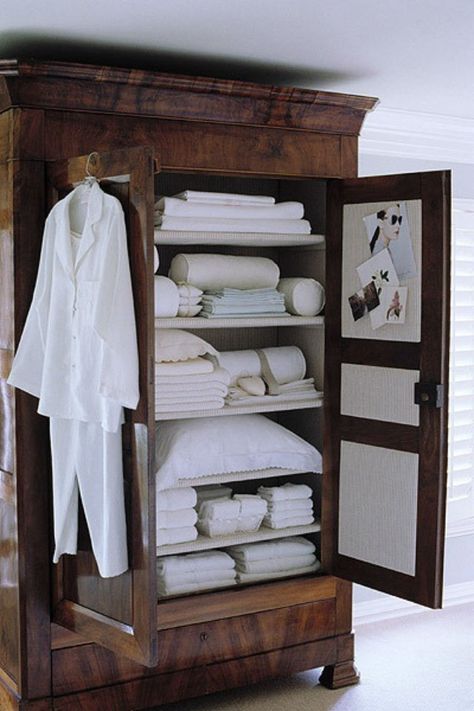 dark-brown-wood-armoire-remodelista Muebles Shabby Chic, White Linens, Wood Armoire, Linen Cupboard, 아파트 인테리어, Massage Room, Linen Storage, Tiny Bedroom, Cool Ideas