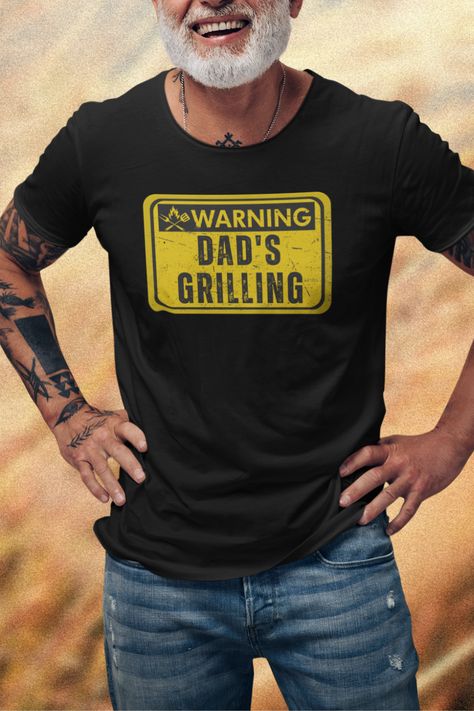 Fire up the laughter and celebrate Father's Day with our hilarious "Dad's Grilling" t-shirt! It's the perfect attire for the master of the grill who turns every backyard BBQ into a sizzling success. Father's Day t-shirts for dads, Funny Father's Day t-shirts for new dads, Father's Day t-shirts for grandpas who are the best, Unique Father's Day t-shirts, fathers day tee shirt ideas, funny fathers day shirts, fathers day graphic tees. Fathers Day Graphic, Tee Shirt Ideas, Tees Outfit, Dad Tshirt, Dad Shirts, Graphic Tee Outfits, Father's Day T Shirts, Funny Fathers Day, Backyard Bbq