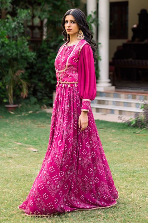 Magenta pink bishop sleeve padded bodice anarkali with all over bandhani print. Paired with a sleeveless bandhani print jacket with tassels. Components: 2 Pattern: Print Type Of Work: Bandhani Neckline: Round Neck Sleeve Type: Bishop Sleeves Fabric: Silk, Georgette Color: Pink Other Details:  Anarkali: Padded bodice Bandhani print cuffs Gota patti hem Jacket: Front buttons Tassel lace Gota patti detailing Occasion: Puja,Mehendi and Haldi - Aza Fashions Georgette Bandhani Dress, Bandhani Dress Pattern, Anarkali With Jacket, Round Neck Anarkali, Frock Design For Stitching, Jacket With Tassels, Bandhani Fabric, Bandhani Print, Haldi Outfits