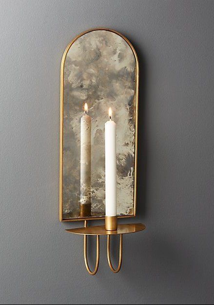 light reflections. Curved iron wall sconce in brass finish holds one taper candle. Antiqued mirror backing brilliantly reflects the light. We love it in pairs flanking a bed or doorway, or clustered in multiples for extra drama. CB2 exclusive. #cb2 #walldecor #entrywaydecor #mirrorwalldecor Candle Sconces Living Room, Wall Sconces Living Room, Antiqued Mirror, Sconces Living Room, Unique Candle Holders, Iron Wall Sconces, Modern Candle Holders, Candle Wall, Modern Candles