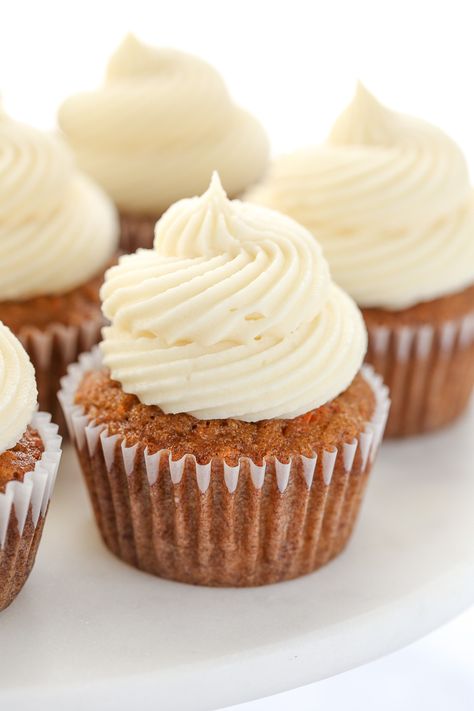 A close up picture of carrot cake cupcakes topped with cream cheese frosting sitting on top of a marble cake stand. Zucchini Cupcakes, Cream Cheese Frosting Easy, Cupcake Cream, Homemade Carrot Cake, Carrot Spice Cake, Cupcakes With Cream Cheese Frosting, Carrot Cake Cupcakes, Pumpkin Desserts, Cream Cheese Frosting Recipe