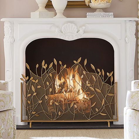 The lacy branch and leaf design was created by our own talented artist. Our Branches Fire Screen is handmade of powder-coated iron and decorated with beautifully detailed leaf details. An antique brass finish is hand applied to give this decorative fireplace guard a warm, golden glow. Branches Fire Screen features: Antique brass finish with gold accents Leaf & branch details Handmade of powder-coated iron Rust-resistant Brass Fireplace Fender, Brass Vent Covers, Decorating With Brass Accents, Inside Fireplace Decor, Faux Fireplace Decor, Fireplace Screen Ideas, Gold Fireplace Screen, Empty Fireplace Ideas, Gold Fireplace