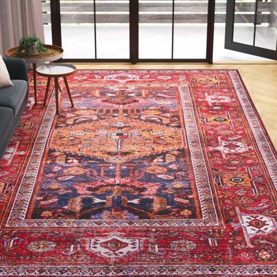 This boho-inspired area rug takes inspiration from traditional Persian textiles for a classic look. A central medallion design features a geometric motif and intricate border, in red and navy blue with just the right amount of fading. Power-loomed from polyester, it has a low 0.16" pile height that makes this rug an ideal base for busy spaces. This rug includes a non-slip backing to help it stay put. Best of all, this rug is stain-resistant, so holds up to regular use and its material makes it r Red And Blue Area Rug, Red Boho Rug Bedroom, Living Room Rug Colorful, Colorful Persian Rug, Blue Couch Red Rug, Persian Rug Aesthetic, Overlapping Rugs, Red Boho Rug, Red Living Room Rug