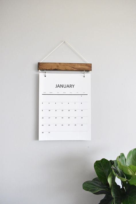 "2022 Monthly Calendar. You can choose a natural hanger or a dark walnut hanger! (IF YOU PURCHASE A REFILL, THEY DO NOT COME WITH PRE PUNCHED HOLES UNLESS REQUESTED) Printed on card stock paper. Calendar sizes: 8.5\" x 11\" 11\" x 17\" Dates: January 2022 - January 2023 Comes with a handmade wooden hanger and metal hooks to hold the calendar pages on. Easy to switch the pages every month. Hang the calendar by the string attached to the wooden hanger. This would make a great gift! Once you place Calendar Wall Decor, Wall Decor Simple, Wall Calender, Paper Calendar, Wall Calendar Design, Wood Calendar, Modern Calendar, Kalender Design, 달력 디자인