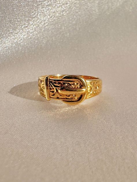 Vintage 9k yellow gold belt buckle ring from Birmingham, England. The belt buckle was a popular motif during the Victorian era in which it symbolized ones love being fastened for eternity. Excellent vintage condition Size: 7.75 resizable* Weight: 3.1 grams Band: 7.7 mm (front), 3.0 mm (back) Hallmarks: 375 for 9k, anchor for Birmingham Belt Buckle Ring, Vintage Ring Stack, Vintage Jewelry Aesthetic, Gold Vintage Rings, Cool Rings, Gold Belt Buckle, Fantasy Earrings, Belt Ring, Vintage Gold Rings