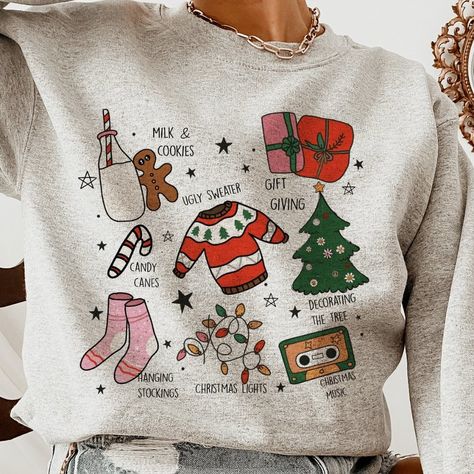 Step Into The Season Of Joy With Our 'Christmas Traditions Illustrated Sweatshirt'. Boasting Vibrant Hand-Drawn Illustrations That Capture The Essence Of The Holidays, From The Warmth Of 'Milk & Cookies' To The Fun Of 'Ugly Sweaters'. This Cozy Pullover Comes In A Variety Of Colors And Sizes, Available Exclusively On Our Website. Lovingly Crafted By Our Small Business, It's More Than A Sweatshirtit's The Spirit Of Christmas Wrapped In Comfort. Desert Bloom, The Spirit Of Christmas, Spirit Of Christmas, Woven Sweater, Winter Shirts, Cozy Pullover, Christmas Hoodies, Warm Sweaters, Christmas Designs