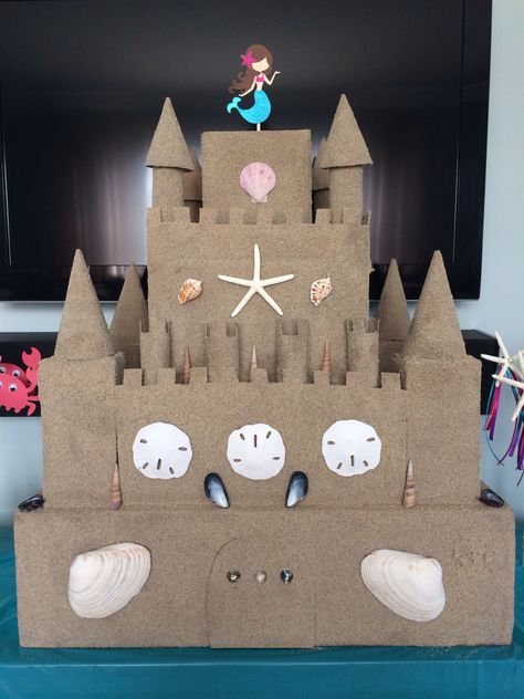 Sand castle -made from cardboard and glued on sand Diy Sandcastle Cardboard, Breaker Rock Beach Sand Castle, Beach Parade Float, Diy Sand Castle Decoration, Cardboard Sandcastle, Diy Sandcastle, Vbs Lighthouse, Sand Castle Ideas, Sand Castle Craft