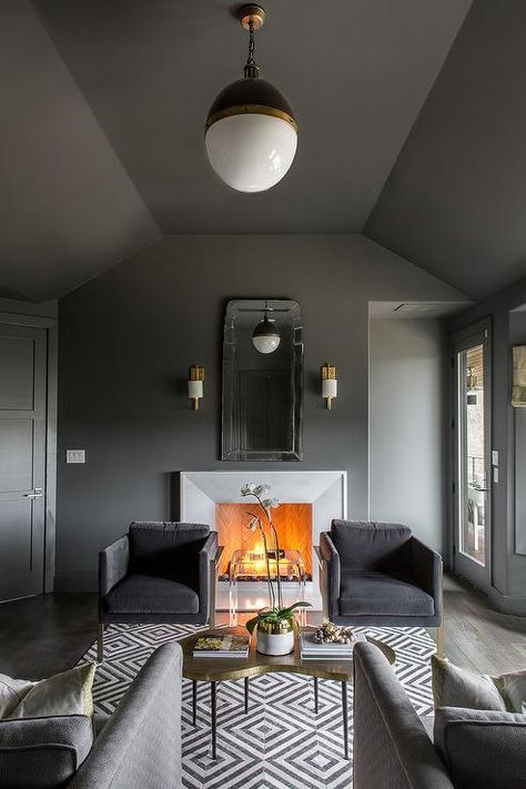 Gorgeous masculine gray den is lit by a Small Hicks Pendant hung from a charcoal gray ceiling painted in Benjamin Moore Kendall Charcoal over a gold kidney shaped coffee table placed on a white and black geometric rug. Grey Ceiling Paint, Dark Grey Room, Interior Design Gray, Outdoor Dining Decor, Perfect Grey Paint Color, Monochromatic Living Room, Perfect Grey Paint, Home Ideas Kitchen, Monochromatic Interior Design