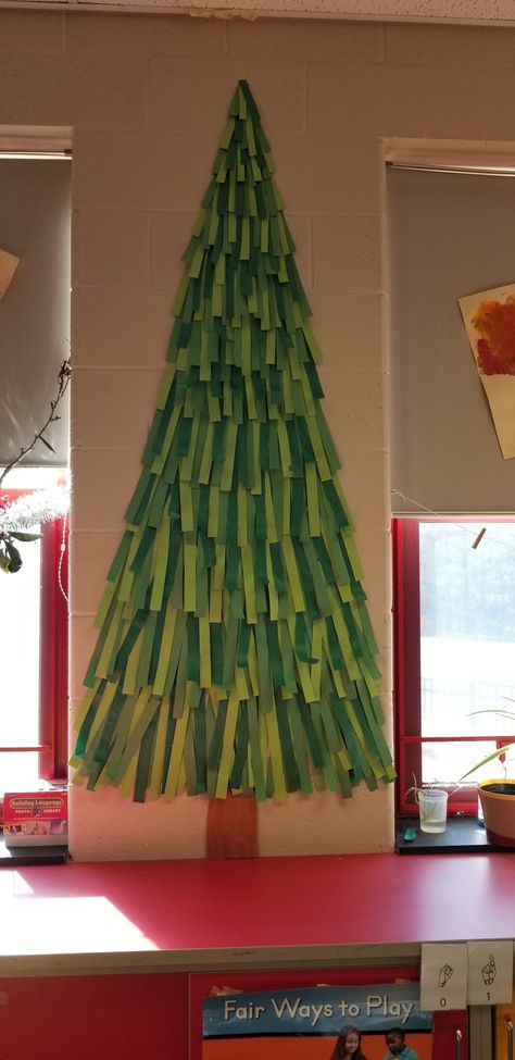 Big Paper Christmas Tree On Wall, Christmas Tree On Door Classroom, Wall Christmas Tree Paper, Christmas Tree With Construction Paper, Christmas Classroom Decorations Wall, Wrapping Paper Christmas Tree On Wall, Paper Christmas Trees For Classroom Wall, Paper Wall Christmas Tree Ideas, Christmas Tree Display Board