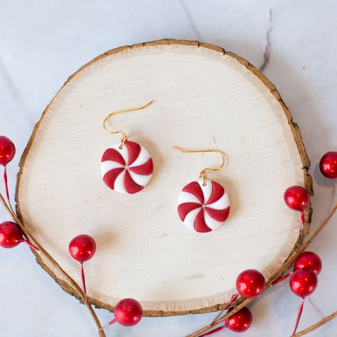 Christmas/Holiday Peppermint Candy Earrings, Lightweight Festive Dangle Earrings, Handmade Polymer Clay Earrings Polymer clay earrings are extremely lightweight and comfortable to wear. These earrings are handmade, so you may notice slight variations in the product pictured and the one you receive. The hooks are gold plated over brass, silver hooks are available upon request. ▪CARE INSTRUCTIONS▪ Store your earrings in a way where the metal backs will not scratch your clay earrings. Avoid sleeping in or bending your earrings. Polymer clay earrings are very durable, but can break if force is applied. If needed, you can clean them with a damp cloth or baby wipe.  If you have any questions, please feel free to message me! ♡ Holiday Earring Ideas, Clay Sweater Earrings, Christmas Polymer Clay Earings, Clay Earrings Holiday, Simple Christmas Polymer Clay Earrings, Candy Cane Clay Earrings, Clay Christmas Jewelry, Christmas Clay Earring Ideas, Christmas Earrings Clay