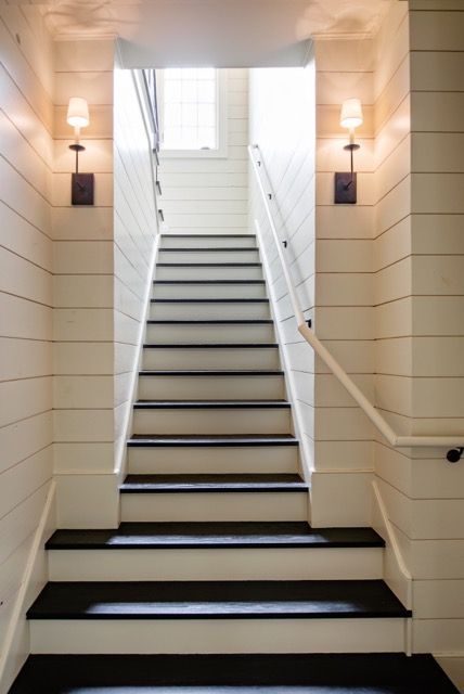 Wood paneling adds rustic charm to this beautiful staircase.  #staircase #kitchendesign "A Fresh Take On Traditional Design" http://www.StyleBlueprint.com Farmhouse Stairs, Residence Design, Shiplap Cladding, Basement Stairs, Gorgeous Houses, Foyer Decorating, Neutral Interiors, Basement Flooring, Unfinished Basement