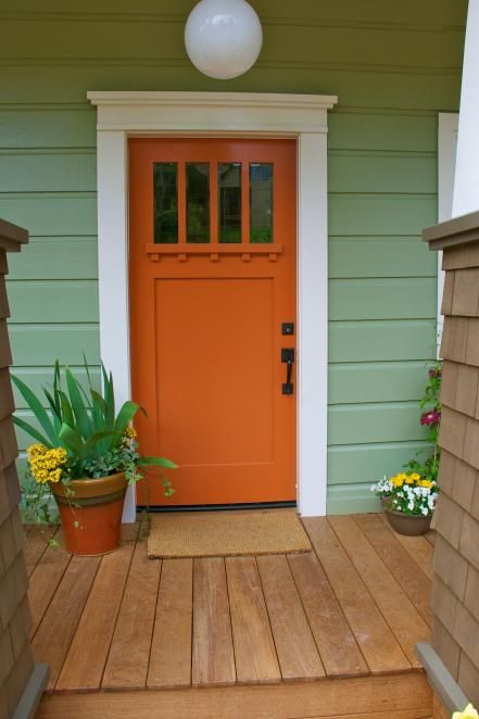 This bright orange door's sturdy structural elements stay true to the home's Craftsman style. While the home's exterior is a sage green hue, designer John Gidding swings to the other side of the color wheel for a front door color with true contrast. Orange Front Door, Sage Green House, Exterior Door Trim, Curbside Appeal, Orange Front Doors, Unique Front Doors, Best Front Doors, Terrace Ideas, Orange Door