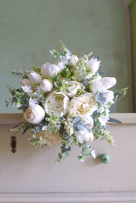 An elegant wedding bouquet in an immortal white-cream combination is made of textile flowers of dahlias, spiers, peonies, tulips and milkweeds. All flowers are carefully selected to look as alive. Peonies And Lavender Bouquet, Formal Bridal Bouquet, Wedding Bouquets Bride Peonies, Romantic Wedding Bouquet Vintage, Flowy Wedding Bouquets, Wedding Florals Peonies, Wedding Flower Arrangements Peonies, Bridal Bouquet Flower Types, Dahlia Peony Bouquet