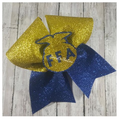 $12 you can buy this on Facebook BowsOnTheLow. FFA hair bow. Blue and gold cheer bow. Feature farmers of America bow Cheer Bow, Ffa, Cheer Bows, Blue And Gold, Hair Bow, Science And Technology, Agriculture, Hair Bows, Science