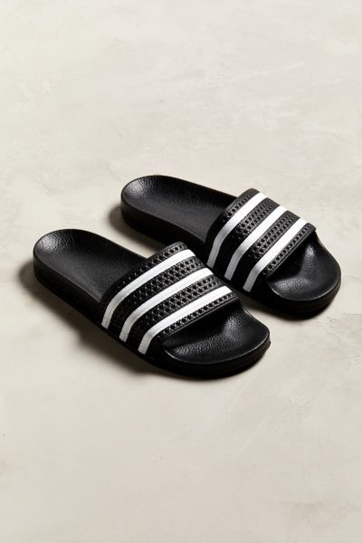 Favorite pool slides from adidas. Slip-on silhouette offers a textured three-stripe foot strap and a contoured footbed for comfort. Finished with a grippy rubber outsole.Content + Care. Rubber Spot clean Imported Adidas Slides Outfit, Sport Sandals Outfit, Adidas Sandals, Slides Outfit, Image Moto, Wu Wear, Mens Slide Sandals, Adidas Slides, Men Slides