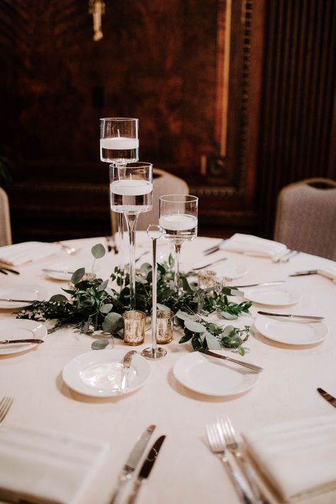 Mixed greenery and eucalyptus with stemmed floating candle vases by Creations By Debbie in Nashville, TN.  #NashvilleWeddings #UnionStationNashville #WeddingCenterpieces Circle Table Centerpiece Wedding, Circle Table Wedding Decor, Floating Candle Vases, Floating Candles Mason Jars, Glass Candle Holders Centerpiece, Candle Vases, Floating Candle Vase, Eucalyptus Centerpiece, Modern Wedding Centerpieces