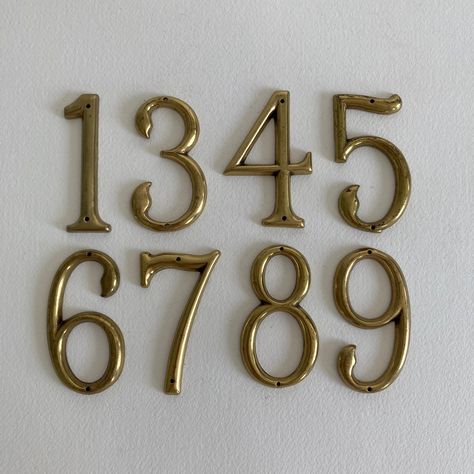 SOLD PER NUMBER Numbers Available: 7 Vintage brass house numbers with original patina present on each number.  The level of patina/ finish does vary from number to number.  Exact date of production unknown. Mid to Late 20th Century. Markings: - No markings present Condition: - Original vintage condition with wear appropriate for age - In untouched state -- brass has not been polished - Level of patina/ finish does vary from number to number - Original patina present on each number Measurements: - Height - between 2 3/4"to 3" inches tall - Width - approx. 1 1/2" inches wide Shipping: - Item will ship within 1-3 business days - Item will ship via USPS Ground Advantage, UPS Ground, or UPS Ground Saver - Shipping Upgrade Option: USPS Priority Mail for an additional fee of $15.00 for the first Brass House Numbers, Spartanburg Sc, Address Signs, Patina Finish, Humble Abode, House Number, Address Sign, House Address, House Goals