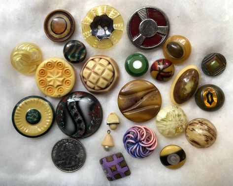 This group of very vintage sewing buttons includes a variety of types, shown with a quarter coin for size. It is my intention to offer celluloid and early plastics in this assortment, part of an enormous collection I bought many years ago.  There is one extruded, and a couple with mother-of-pearl centers.--many diverse designs. The second image shows the backs of the buttons in the same arrangement as the first image. Photos accurately show the light wear on these sweet old buttons. Shipping is Vintage Buttons Antiques, Fancy Buttons, Sewing Buttons, Button Crafts, Sewing A Button, Vintage Buttons, Vintage Sewing, Painted Rocks, Mother Of Pearl