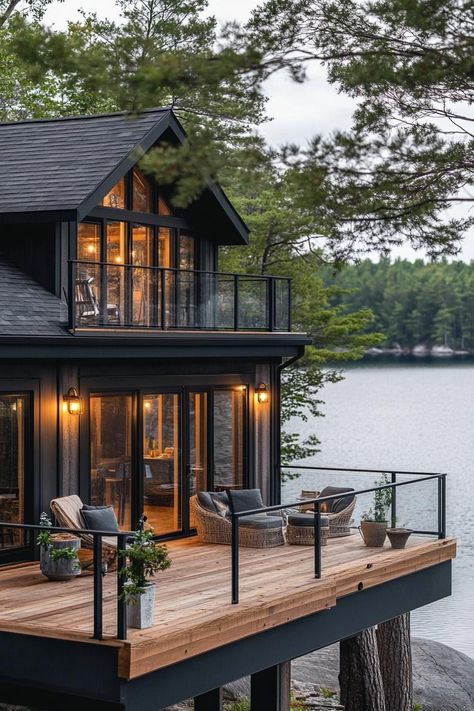 Rustic modern lake house facade with wraparound timber porch stunning Scandinavian lake view. Check out all of these charming and cozy rustic lake houses that perfectly blend with nature for the ultimate peaceful retreat. Lake House Shoreline, Chalet Lake House, Exterior Lake House Ideas, Cozy Lake House Exterior, Lake Mountain House, Building A Lake House, Big House Design Exterior, Lake House Screened In Porch, Minimalist Lake House