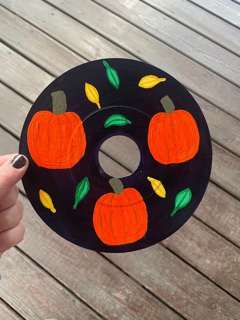 "Fall | Fall Decor| Vinyl Record Painting | Painted Vinyl Record | Pumpkins and Leaves Created by painting with acrylic paint on a 7\" vinyl record.  Titled- \"Fall Vibes\"  Custom piece can be created with different colors." Record Painting Ideas, Painted Vinyl Record, Painting With Acrylic Paint, Vinyl Record Painting, Vinyl Record Wall Art, Painted Vinyl Records, Record Wall Art, Pumpkins And Leaves, Record Painting