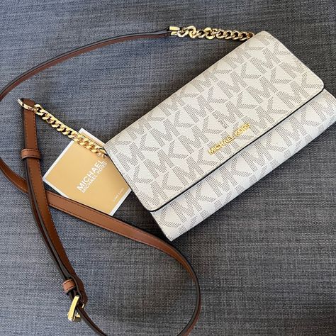 Brand New Hard To Find Mk Large Phone Crossbody Bag Clutch Vanilla Color With Mk Signature Design Gold Hardware Mk Lettering On The Front Detachable Long Strap 25" Drop Flap With Snap Closure Interior: One Bug Compartment For Your Phone One Zipper Compartment One Currency Compartment Approximately 8"L X 5.25"H X1.5"W Iphone 8 Fits Into It Pet & Smoke Free Home Please See My Entire Collection Mk Crossbody Bag, Vanilla Color, Luxury Tote Bags, Luxury Bags Collection, Handbag Essentials, Mk Purse, Michael Kors Crossbody Bag, Women's Bags By Style, Designer Purses