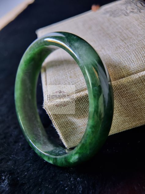 Experience the natural beauty of this 57mm dark green jade bangle, a one-of-a-kind treasure from our unique collection. Its deep, rich green color exudes elegance and tranquility, making it the perfect accessory for any outfit. Ideal as a special Christmas or New Year gift, this exclusive jewelry piece adds a timeless touch to your loved one's collection. Jade Bangle, Rich Green, New Year Gift, Exclusive Jewelry, Green Jade, Christmas Special, Jade Green, New Year Gifts, Perfect Christmas