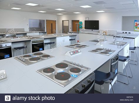 Domestic Science / cookery classroom in a new, London secondary school. Shows hobs and ovens and teachers bench beyond. Stock Photo Cooking Room School, Cooking School Interior, Cooking School Design, Cooking Class Kitchen, Cooking Classes Design, Demo Kitchen, Cooking School Kitchen, Kitchen Island Shapes, Domestic Science