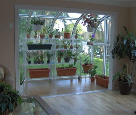 The gardener in me SCREAMS for an indoor solarium! How much would this cost? Get rid of my livingroom bay window, or my kitchen slider? Indoor Solarium, Serre Diy, Greenhouse Kitchen, Greenhouse Window, Greenhouses For Sale, Indoor Greenhouse, Greenhouse Interiors, Small Greenhouse, Greenhouse Plans