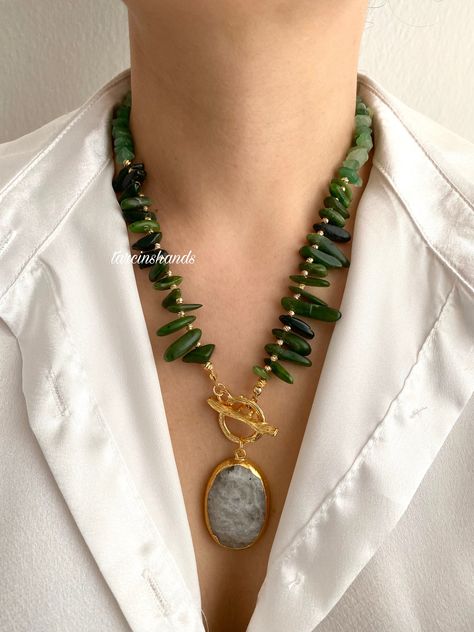 🌿Gold-Plated Necklace with Green Jade, Aventurine Stones, and Moonstone Pendant - 18 Inches🌿 Embrace the elegance of nature with our **Gold-Plated Necklace featuring a harmonious blend of **Green Jade** and **Aventurine Stones**. This handcrafted piece is designed to add a touch of serenity and sophistication to any ensemble. ✨ **Premium Materials This necklace is meticulously crafted with gold plating, ensuring durability and a lasting shine. The combination of green jade and aventurine stone Green Jade Necklace, Earthy Necklace, Green Gemstone Necklace, Aventurine Necklace, Beaded Jewelry Necklaces, Aventurine Stone, Toggle Necklace, Necklace Chunky, Beaded Pendant Necklace