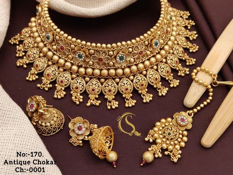 Description :- Gold Choker Necklace Sets / South Indian Jewelry/Punjabi Choker/ Temple Necklace /Antique Wedding choker Necklace/Indian Wedding Jewelry All the raw material used in this product is of high quality and is handcrafted with love. Premium Quality and High craftsmanship 100% Satisfaction Guarantee: Long Lasting Plating, High-Quality Stones. Gifting: This pair of charming necklace and earrings come in a beautiful gift box, making it an ideal gift for birthday, wedding anniversary or we Choker Necklace Indian, Amrapali Jewellery, Wedding Choker Necklace, Choker Sets, Indian Gold Jewellery Design, Temple Necklace, Bridal Jewelry Sets Brides, Indian Choker Necklace, Frock Designs