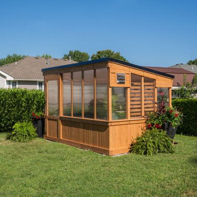 Elevate your gardening with a modern greenhouse masterpiece. Step inside and you'll discover a spacious interior that invites you to dig into your passion for gardening like never before. Combining forced and passive ventilation, you can nurture plants year-round. And features like foldable shelves, a hose hook-up, and PowerPort™ make it complete so you can unleash your green thumb in style. | Backyard Discovery 12 x 7 Zalie Modern Greenhouse 94.1 H x 86.22 W x 137.8 D in brownWood / Polycarbona Garden Shelves Outdoor, Foldable Shelves, Passive Ventilation, Modern Greenhouse, Cedar Greenhouse, Modern Greenhouses, Polycarbonate Greenhouse, Garden Shelves, Polycarbonate Panels