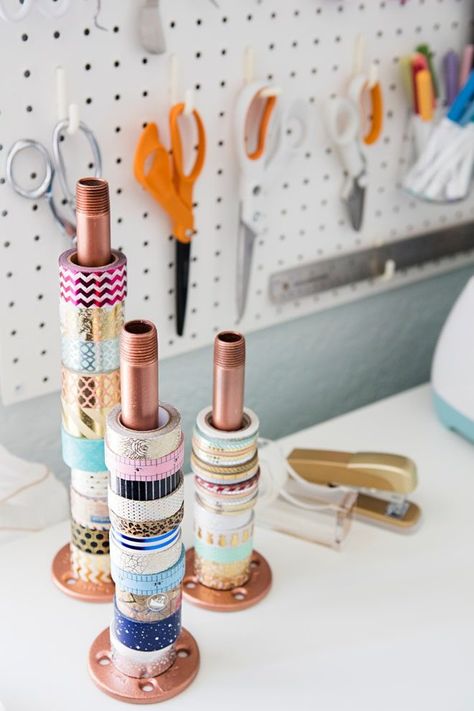 These pipe washi tape holders are a very unique way to store your tapes! They're a great touch to your craft room for those of us who are a little metallic crazy (that trend will never end in my house!). | Craft supplies getting a little out of control and in need of some craft storage ideas? Check out more ideas at A Visual Merriment | #craftstorage #craftsupplies #craftorganizing #craftroom #organization #handmade #storage #diystorage #washitape #washitapestorage Rangement Art, Washi Tape Storage, Tape Storage, Tape Ideas, Dream Craft Room, Craft Room Design, Craft Area, Office Crafts, Craft Room Storage