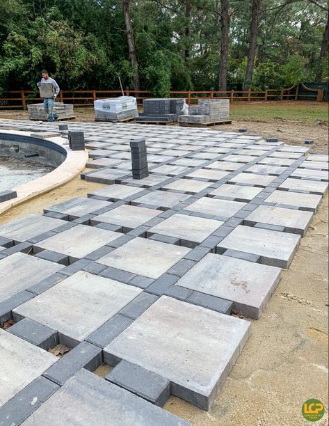 We love seeing your creativity! Be sure to tag us in your next LCP project to be featured. This design is from Nature’s Images, installation by BOC Pavers. #lowcountrypaver #pooldeck #patiodesign #outdoorliving #lowcountrylife #hardscapes #backyarddesign 12x12 Concrete Paver Ideas, Diamond Pavers With Turf, Garden Pavers Ideas, Pavement Design Paving Pattern, Outdoor Walkway Ideas Pathways, Pavers Around Pool, Paver Pool Deck, Paver Patio Ideas, Paver Deck