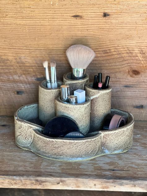 *Introducing our Versatile Handcrafted Ceramic Holder, an elegant solution for organizing your makeup brushes and various accessories. Crafted with precision in our studio, this piece is not only functional but also adds a touch of sophistication to any vanity or space. Versatility and Design: *Originally designed as a makeup brush holder, this ceramic piece is versatile enough to accommodate a variety of items. It's perfect for keeping your vanity tidy by holding brushes, eyeliners, and lipsticks, or it can be repurposed in other spaces to hold pens, art supplies, or even kitchen utensils. Elegant Aesthetics: *The sleek design and fine craftsmanship make this holder a stylish addition to your bathroom, bedroom, or any part of your home. Its minimalist yet chic appearance complements any d Ceramic Make Up Organizer, Ceramic Sunglasses Holder, Pottery Paintbrush Holder, Aesthetic Makeup Brush Holder, Pottery Makeup Brush Holder, Pottery Makeup Organizer, Ceramic Lipstick Holder, Ceramic Bedroom Decor, Aesthetic Home Accessories