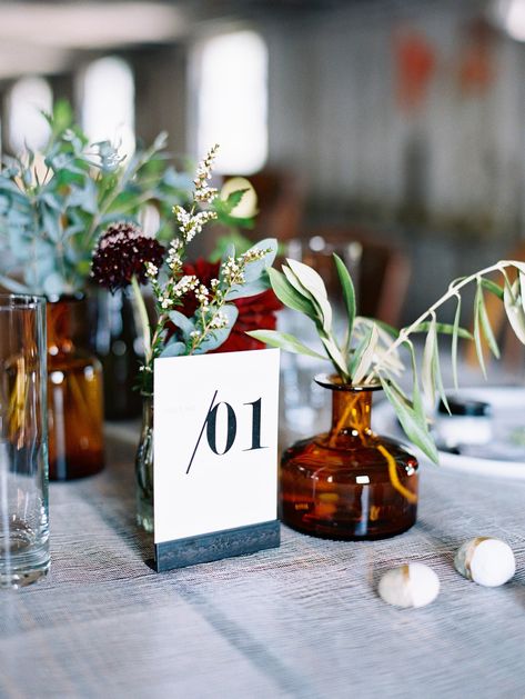 This couple knew they wanted blackened steel table number holders, but couldn't find what they were looking for, so they ultimately asked a friend to create them. They completed the look with a modern printed number that identified each table. Modern Coastal Wedding, Salt Favors, Wedding Table Display, Wedding Photo Display, Diy Wedding Table, Wedding Table Designs, Table Number Holders, Nature Inspired Wedding, Blackened Steel