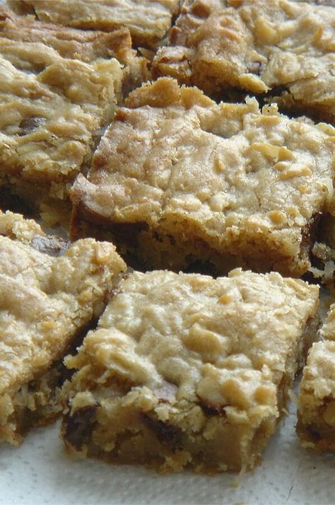 Chewy Coconut Bars | "This is an easy tasty recipe that gives a unique twist to the typical cookie bar. " #dessertrecipes #dessertideas #sweettreats #bars #dessertbars #barrecipes Rhubarb Coconut Bars, Chewy Coconut Bars, Coconut Chewies Bars, Coconut Chocolate Chip Bars, Coconut Toffee Chocolate Chip Bars, Peanut Butter Bon Bons, Peanut Butter Eggs Recipe, Easy Food Recipes, Trifle Pudding