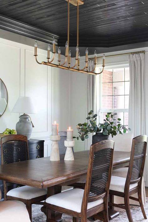 Dining Room With Two Chandeliers, Dining Room High Back Chairs, Light Chairs With Dark Dining Table, White Dining Room Chandelier, Dining Room Table Chandelier Modern, Gold Ceiling Dining Room, Dinning Room Chandeliers, Dining Room With White Walls, Dining Room Black Ceiling