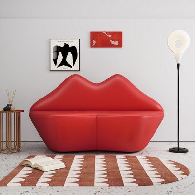 Add a splash of vivaciousness to your decor with the kiss loveseat. This stunning piece is hand-upholstered in smooth faux leather, taking the iconic image of bold lips and transposing them onto a seat that is expertly designed for lounging. The kiss infuses fun and whimsy into any decor with its striking curves and sumptuous design. Fabric: Red-L31 | Ivy Bronx 61.8" Vegan Leather Loveseat Faux Leather in Red | Wayfair Lip Couch, Lip Sofa, Library Seating, Leather Interior Design, Candy Room, Memphis Group, Loveseat Sleeper Sofa, Sugar Factory, Boutique Inspiration