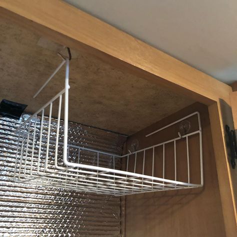 Heavy duty adhesive hooks used to hang an under shelf wire wire basket in the top of a cabinet #rvideas #rvhacks #rvmods #camperhacks… Wire Closet Shelves, Troop Carrier, Shelf Above Bed, Camper Interior Design, Closet Shelf, Camper Hacks, Rv Organization, Camper Storage, Collapsible Storage