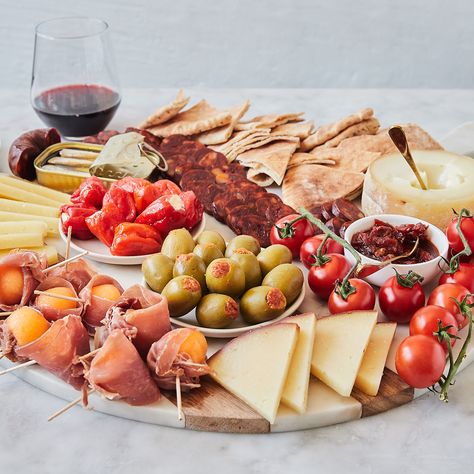 We’re taking a trip to Spain with this DIY tapas-inspired board. A cheese and charcuterie platter that takes snacking to the next level, incorporating some of the best of Spanish and Portuguese flavor onto one party-ready spread. We’ve chosen three incredible cheeses, from approachable Manchego to bold Amanteigado Grande, and paired them with classic chorizo and jamon, as well as sardines. Plus, a selection of sweet, salty, and delectable sides like stuffed peppers and olives, chutney, and ... Portuguese Charcuterie Board, Diy Tapas, Cheeseboard Recipe, Tapas Board, Tapas Party, Trip To Spain, Party Hosting, Cheese Stuffed Peppers, Charcuterie Platter