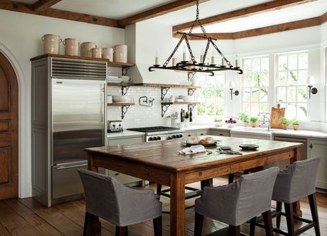 Not All Kitchens Have Islands — The Resurgence of the Center Table. Barbara Westbrook. Classic kitchen with taupe cabinets, marble counters, and rustic beams. Casa Cook, Kitchen Island With Seating, Farmhouse Kitchen Design, Island With Seating, Style Deco, Grey Kitchens, Farmhouse Style Kitchen, Trendy Kitchen, Wood Kitchen