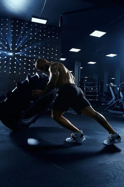 Man moving giant tire wheel in gym | Free Photo #Freepik #freephoto #gym-training #weight-training #gym-exercise #strength-training Visual Photography, Workout Photoshoot, Photography Moodboard, Gym Images, Gym Photography, Workout Routine For Men, Gym Video, Nutrition And Dietetics, Gym Exercise