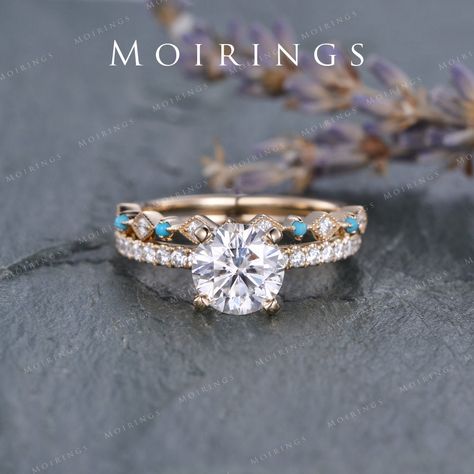 Vintage Moissanite Engagement Ring Set Yellow Gold 7.5mm Moissanite Ring Unique Diamond Turquoise Wedding Band Bridal Solitaire Ring 2pcs ENGAGEMENT RING: ♥ Ring Mounting: 14K Rose Gold ♥ Bandwidth about 1.6mm ♥ Main Stone: Moissanite, D-E-F Clarity Size: 7.5mm, Round Cut. ♥ Accent Stones: natural diamond or colorless moissanite, about 0.28ct Wedding Band: ♥ Ring Mounting: Solid 14K Rose Gold ♥ Band Width: about 1.6mm (back, plain gold part) ♥ Accent Stones: Natural Diamonds or Colorless Moissan Silver And Turquoise Engagement Ring, Wedding Rings Engagement Western, Western Inspired Wedding Rings, Wedding Ring Country, Turquoise Engagement Ring Diamond And, Western Turquoise Wedding Ring, Gold Turquoise Wedding Ring, Turquoise Promise Rings, Engement Rings