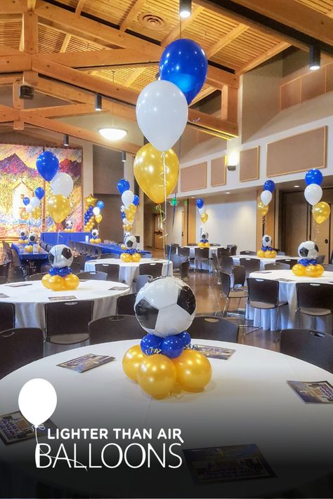 3pc balloon bouquet attached to a low-profile balloon centerpiece with a soccer ball topper for a high school senior night banquet. Soccer Centerpieces, Soccer Senior Night, Soccer Banquet, Soccer Theme Parties, Balloon Table Centerpieces, Banquet Centerpieces, Soccer Birthday Parties, Soccer Theme, Soccer Birthday